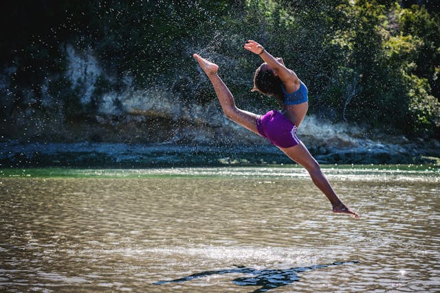 Woman dancing over river joyfully